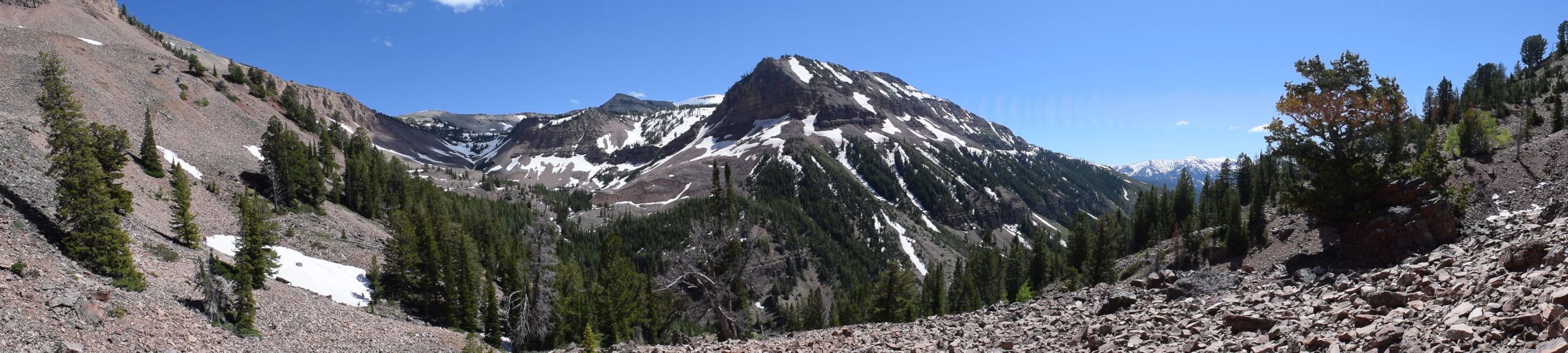 Box Canyon is shown, with rocky slopes, evergreen trees, and a mountain peak.