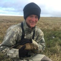 Seth holding a bird during field work.